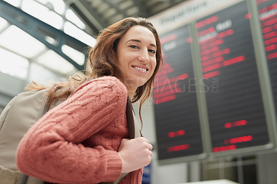 Buy stock photo Low angle portrait of an attractive young woman standing in an airport