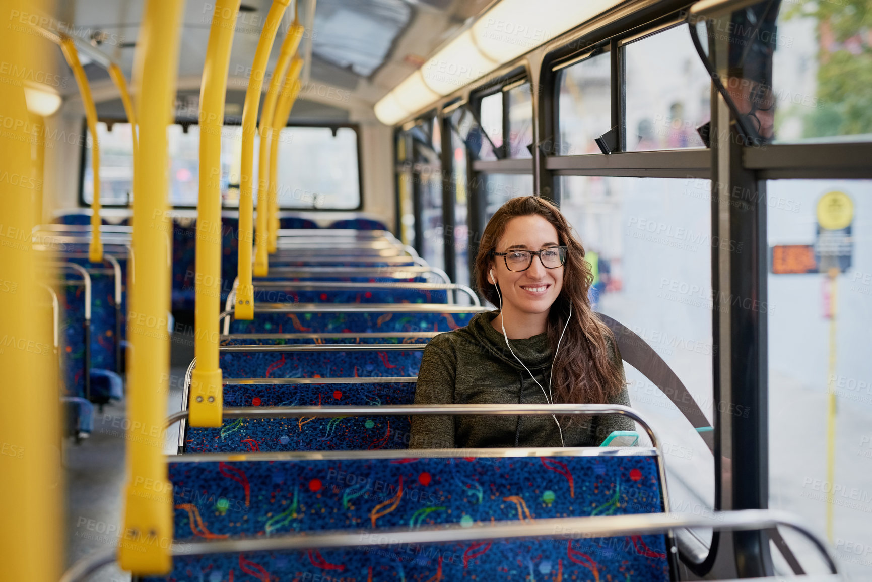 Buy stock photo Woman, bus and earphones with phone for smile, transportation and portrait with social media. Person, music and smartphone for listening with audio streaming subscription on mobile app for commute