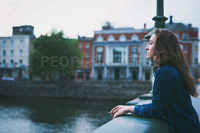 Buy stock photo Woman, cigarette and smoking on bridge in city with memory, depressed or sad by river on winter morning. Person, profile and reflection with tobacco product by water with mental health in Denmark