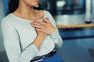 Buy stock photo Closeup shot of an unidentifiable businesswoman holding her chest in pain