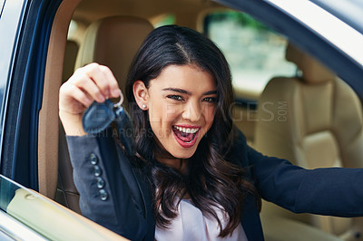 Buy stock photo Shot of an attractive young woman excited about her new car