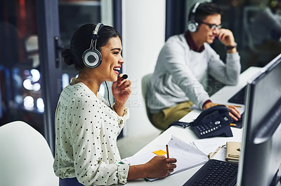 Buy stock photo Shot of young call centre agents working late in an office