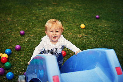 Buy stock photo Outdoor, slide and portrait of cute baby, playground and wellness with games, relax and young in park. Nature, growth and development for child, playing and learning of toddler and lawn of Ireland