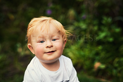 Buy stock photo Shot of an adorable little boy playing in the backyard