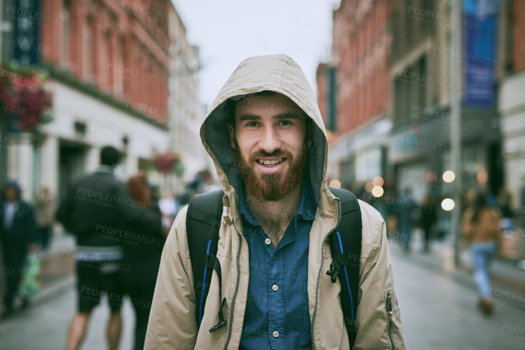 Buy stock photo Cropped portrait of a handsome young man walking through the city