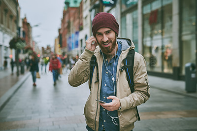 Buy stock photo Travel, city and portrait of man with phone for music, streaming subscription and walking in street. Urban town, happy and person on smartphone with earphones for listening to radio, audio or podcast