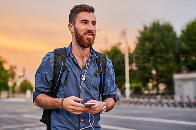 Buy stock photo Man, earphones and music in city for walking, social media and communication with smartphone or backpack. Artist, musician and streaming song for travel, podcast and creative inspiration with mobile