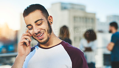 Buy stock photo Cropped shot of a handsome young man making a phone call while standing outside