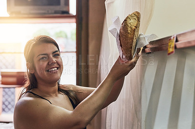 Buy stock photo Cropped shot of a young woman working in her bakery