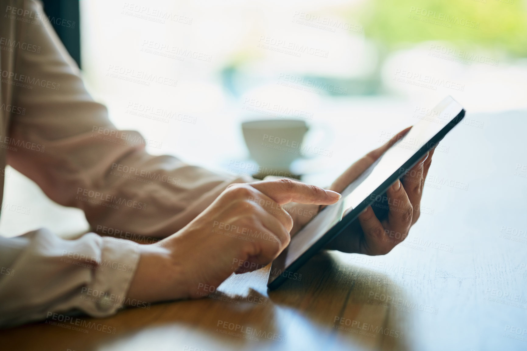 Buy stock photo Closeup shot of an unidentifiable businesswoman using a digital tablet in an office