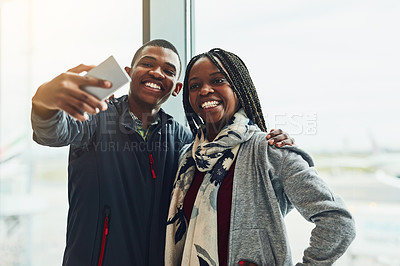 Buy stock photo Cropped shot of two young people taking a selfie together at the airport