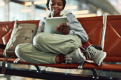 Buy stock photo Shot of a young woman using her digital tablet at the airport