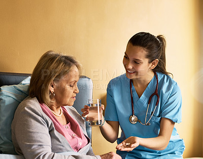 Buy stock photo Cropped shot of a nurse giving medication and a glass of water to a patient