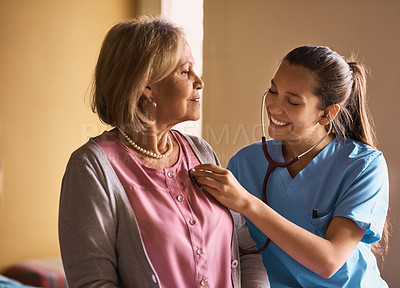 Buy stock photo Cropped shot of a nurse examining a senior patient with a stethoscope
