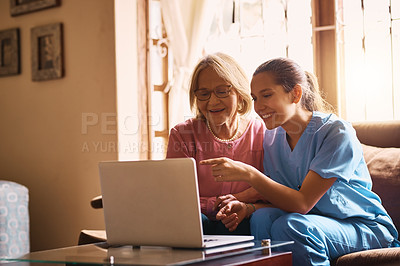 Buy stock photo Shot of a female nurse and a senior woman using a laptop together