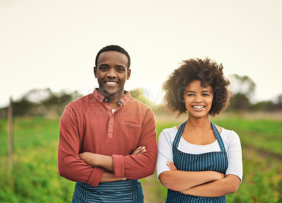 Buy stock photo Cropped portrait of a young farm couple standing with their arms folded