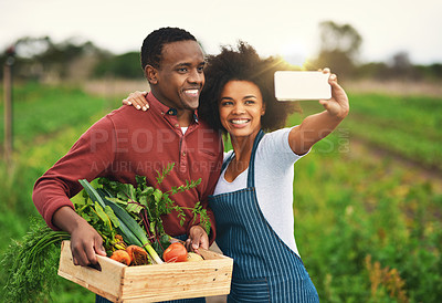 Buy stock photo Cropped shot of an affectionate young couple taking selfies while working on their farm