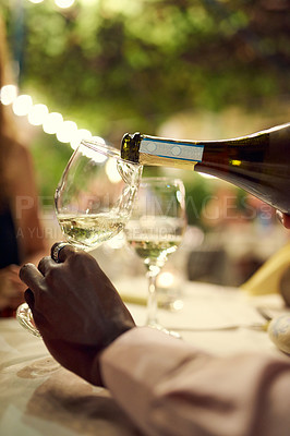 Buy stock photo Person, hands and pouring wine at restaurant on date night for dating, romance and bonding. Closeup, relationship and love with alcohol for conversation, care and trust on break for dinner and relax