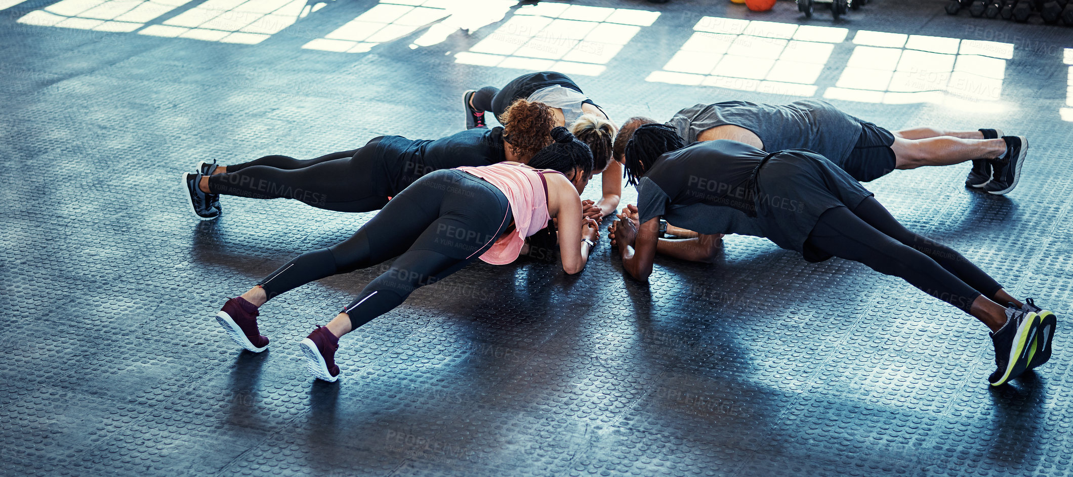 Buy stock photo Shot of a fitness group having a workout session at the gym
