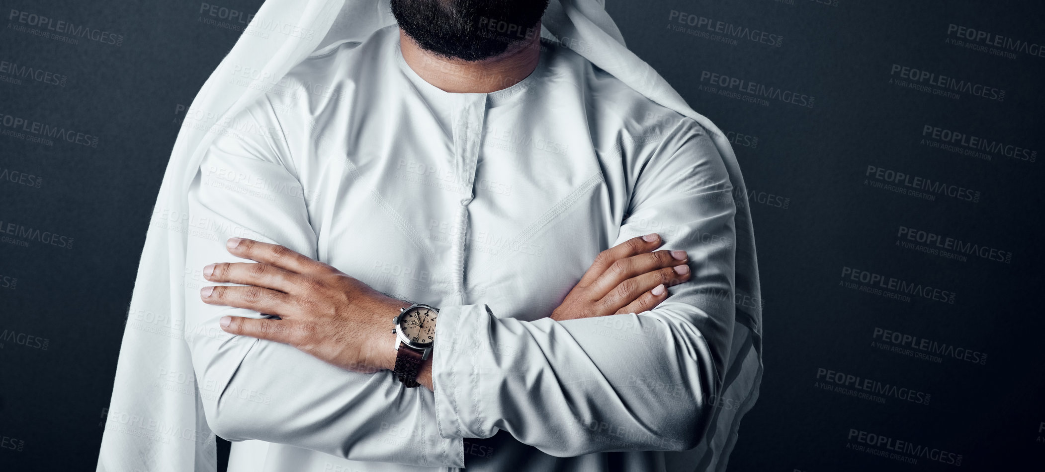 Buy stock photo Studio shot of an unrecognizable man dressed in Islamic traditional clothing posing against a dark background