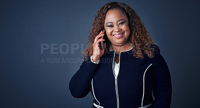 Buy stock photo Portrait of a cheerful young businesswoman talking on her cellphone while looking into the camera