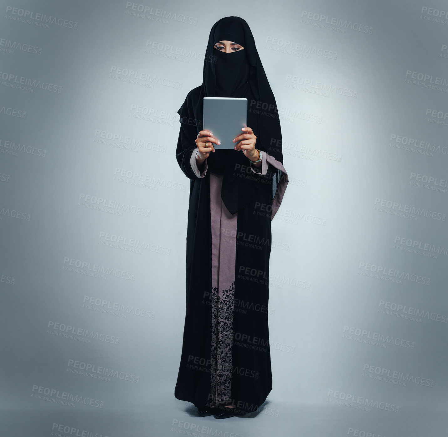 Buy stock photo Technology, reading and muslim woman in studio with space for research or contact for ramadan on app. Tablet, scrolling and islamic female person in burka with communication online by gray background
