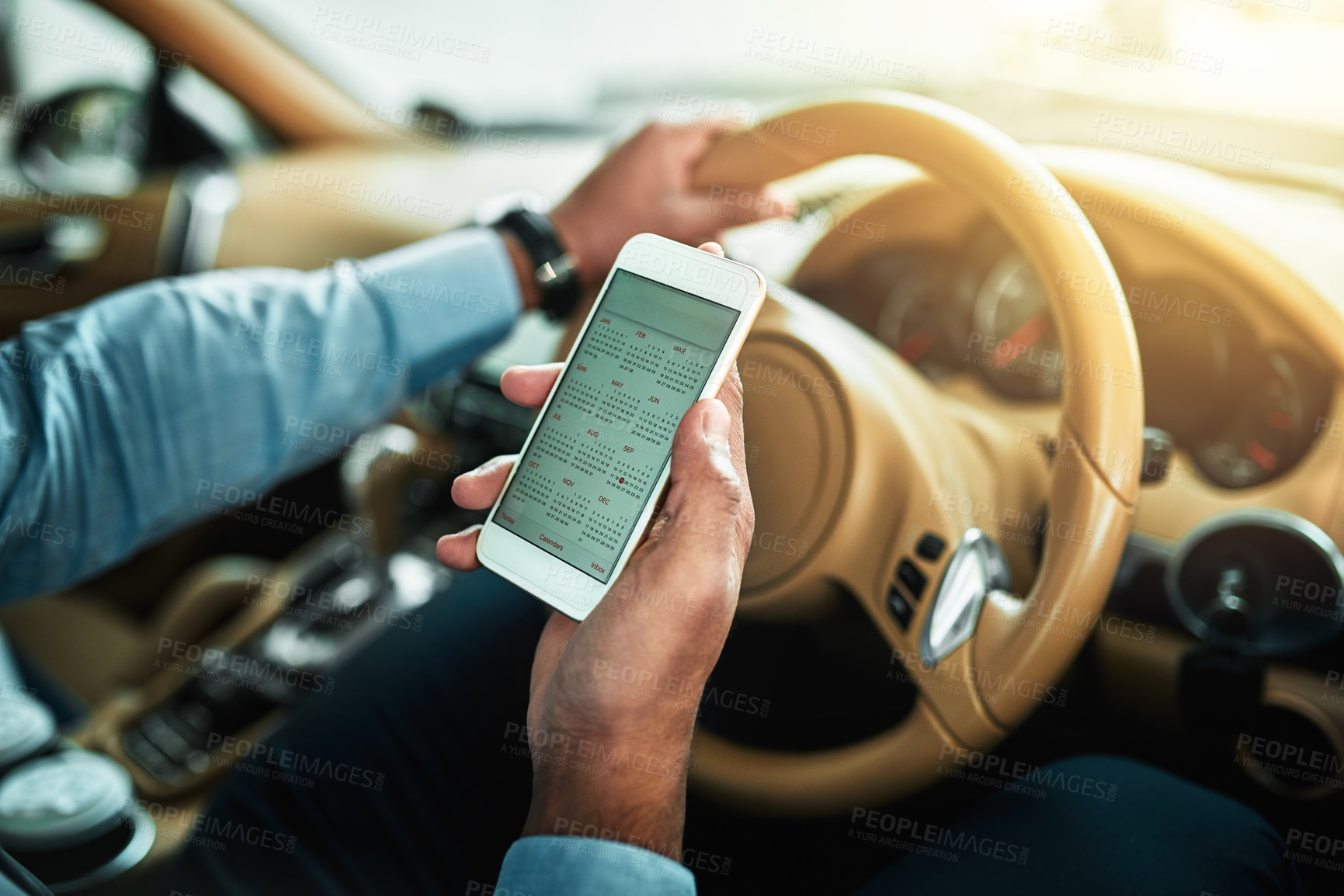 Buy stock photo Closeup shot of an unrecognisable businessman using a cellphone while driving