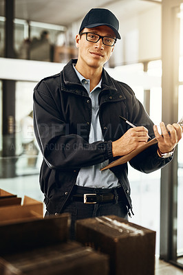 Buy stock photo Portrait of a courier sorting through boxes for delivery
