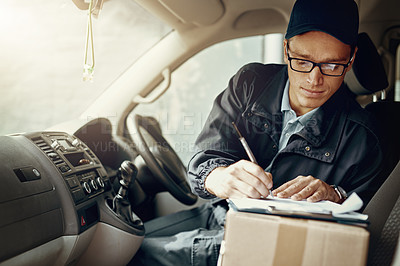 Buy stock photo Shot of a courier making deliveries in his van