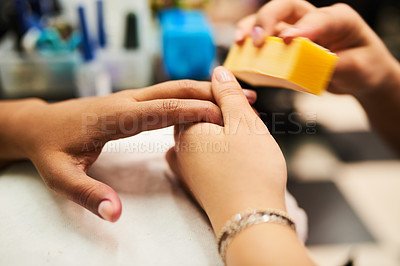 Buy stock photo Closeup of a unrecognisable beautician giving a customer a manicure inside a day spa