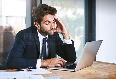 Buy stock photo Tired, laptop and stress businessman lazy with a headache in an office typing on a computer online or the internet. Sleepy, burnout and depressed male corporate person writing a report or research