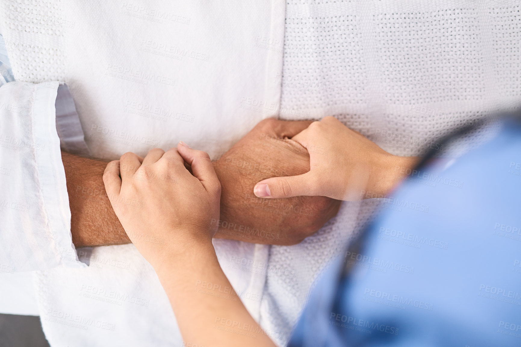 Buy stock photo Closeup of a unrecognisable person's hand being held by a doctor inside a medical clinic