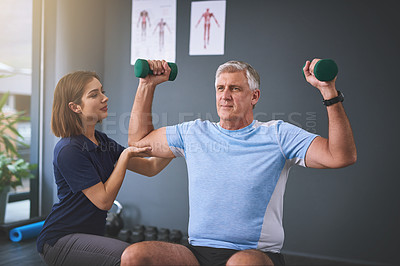 Buy stock photo Cropped shot of a female physician working with a senior male patient