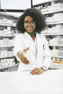 Buy stock photo Portrait of a cheerful young female pharmacist reaching out to shake hands while looking at the camera in a pharmacy