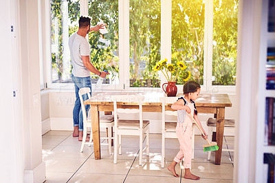 Buy stock photo Shot of a father and his little daughter doing chores together at home