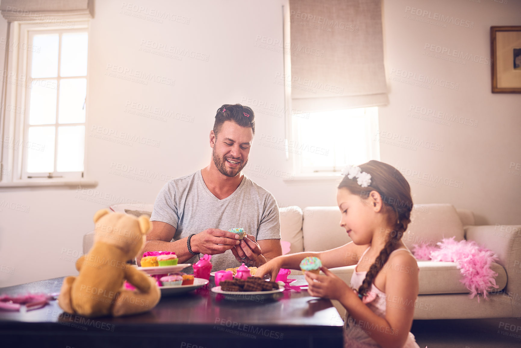 Buy stock photo Shot of a father and his little daughter having a tea party together at home