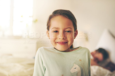Buy stock photo Portrait of a cheerful little girl standing in a bedroom while looking at the camera at home