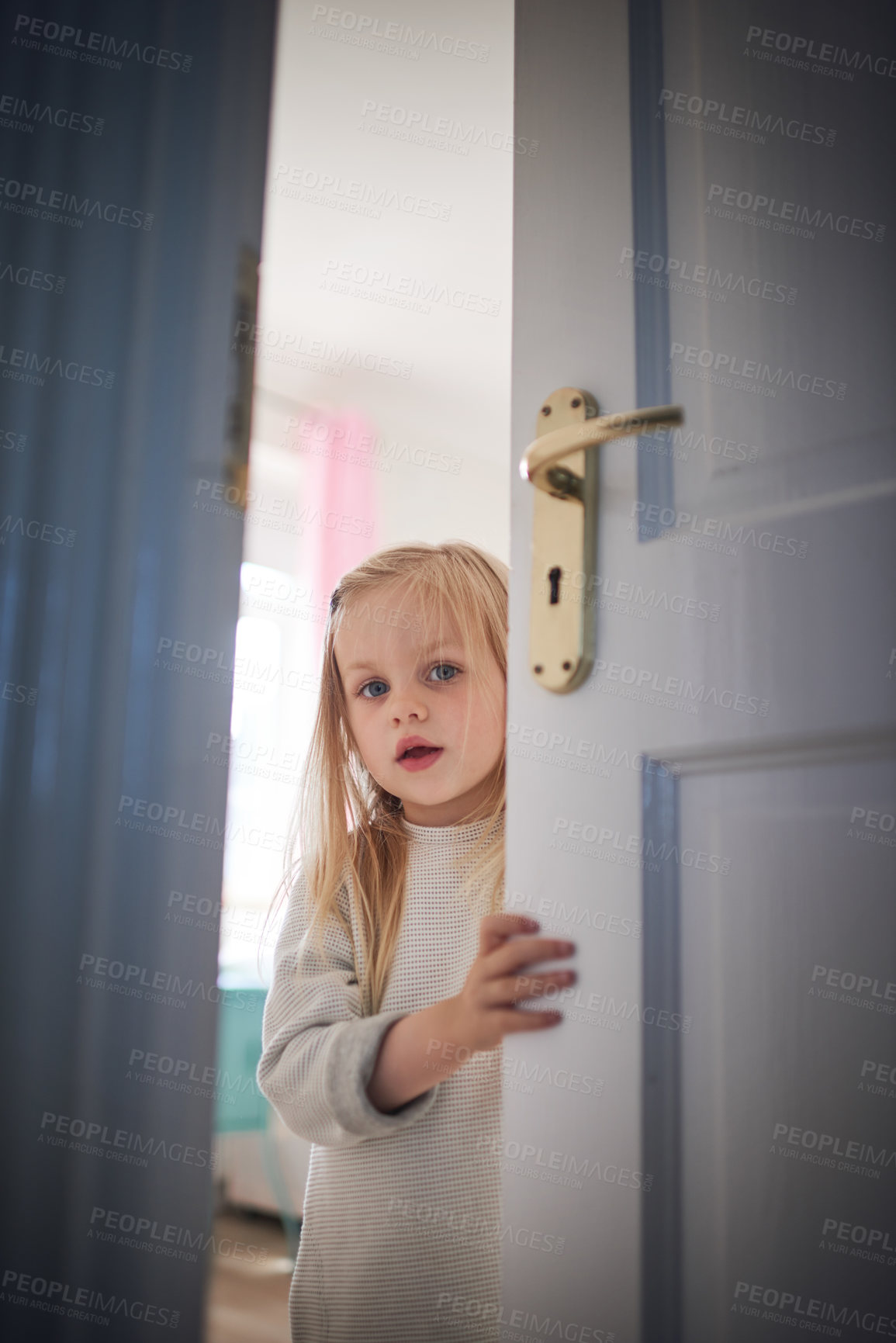 Buy stock photo Shot of an adorable little girl opening a door at home