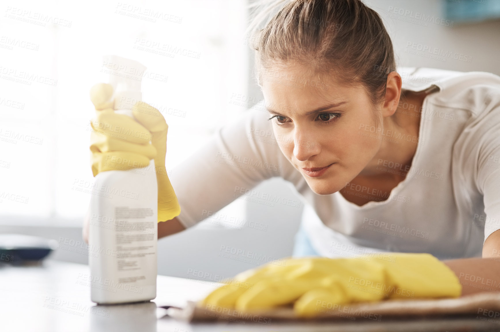 Buy stock photo Cropped shot of a young woman cleaning her home
