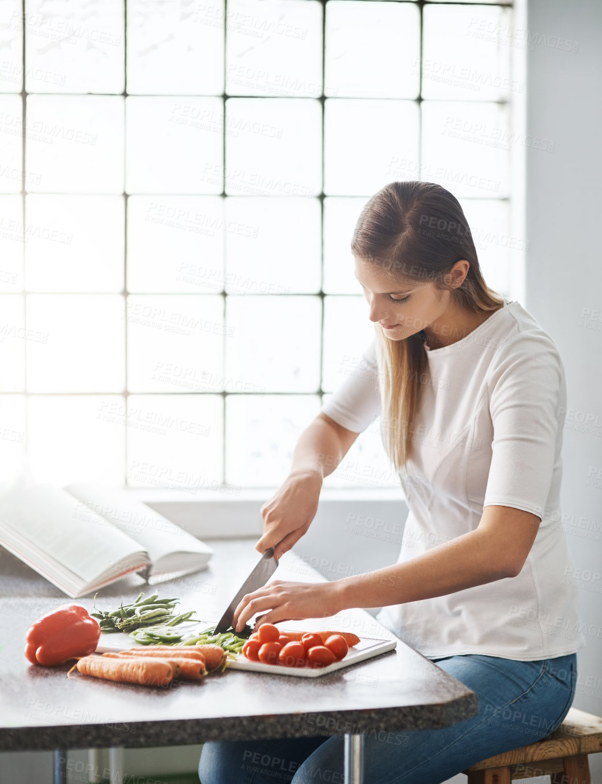 Buy stock photo Cropped shot of a young woman preparing a healthy meal at home