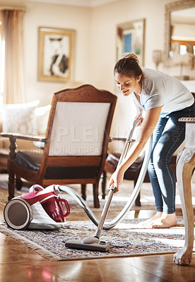 Buy stock photo Woman, cleaning and vacuum with carpet in living room for house work, natural light and furniture. Female cleaner, maintenance and electric machine for dirt in apartment with morning chores and dust