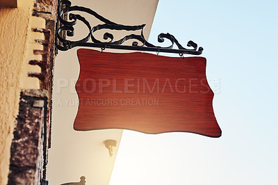 Buy stock photo Cropped shot of a blank sign hanging outside