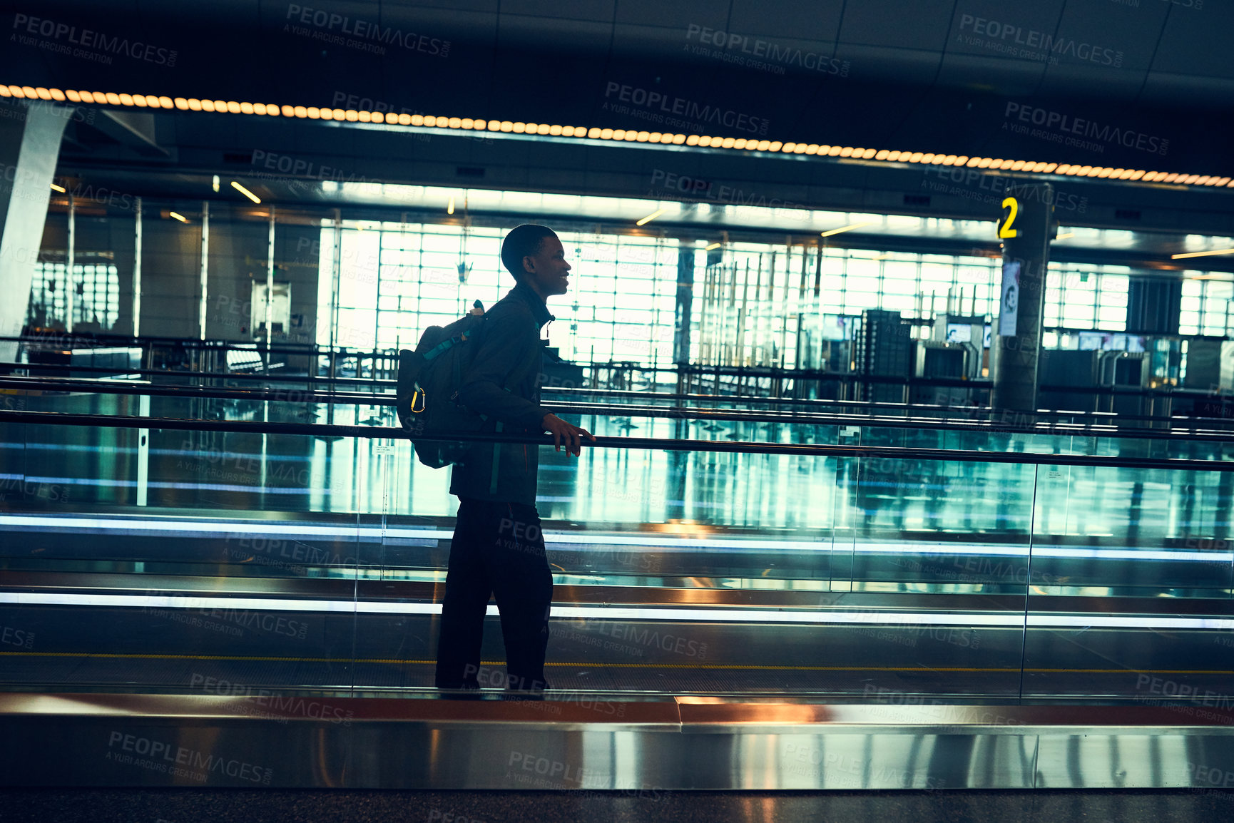 Buy stock photo Moving walkway, travel and black man at airport for flight, vacation and journey. Bag, backpack and happy person at airline on travellator for departure at boarding gate with luggage for holiday trip