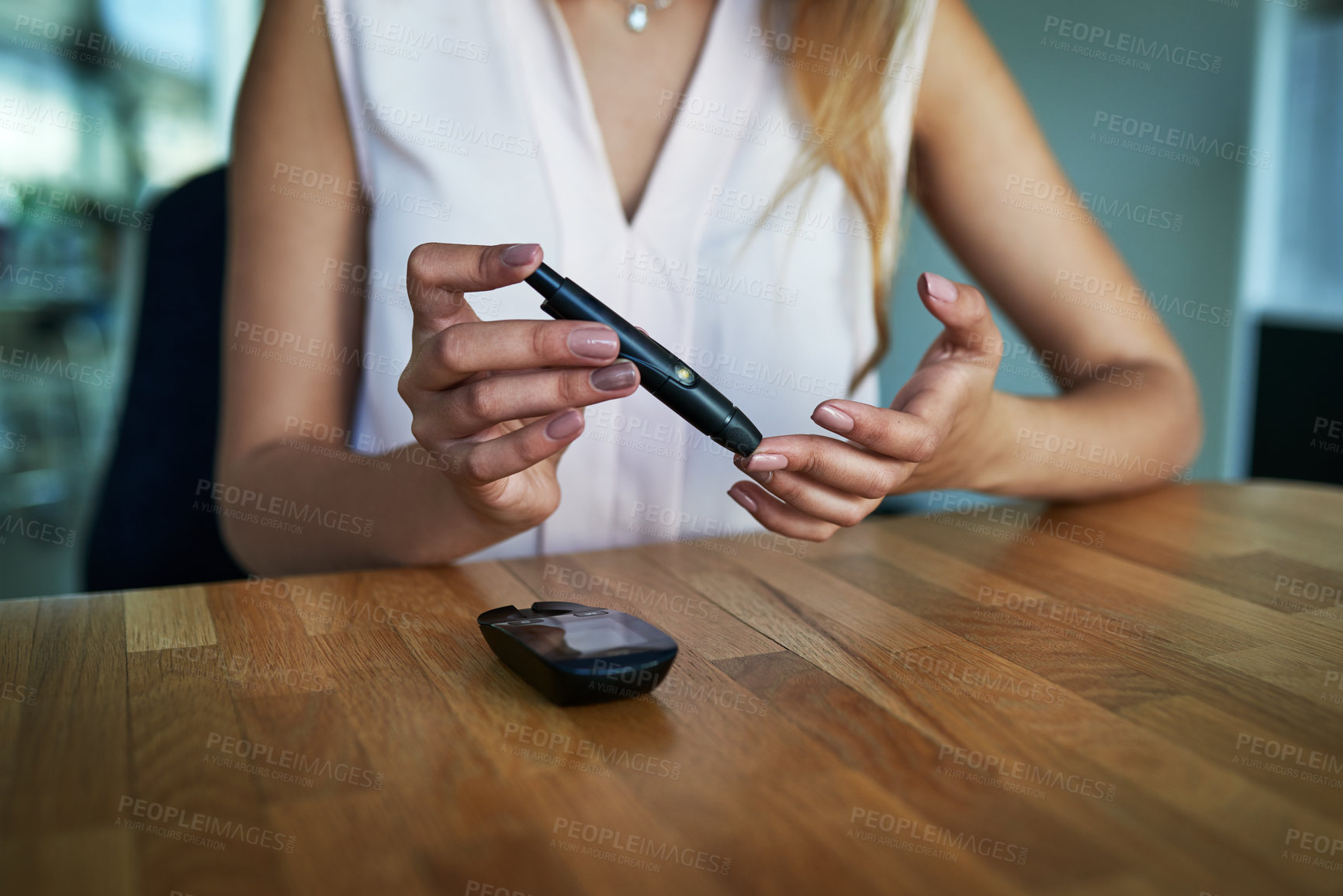 Buy stock photo Closeup shot of an unidentifiable businesswoman testing her blood sugar level in an office