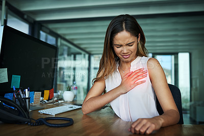Buy stock photo Shot of a young businesswoman suffering with chest pain while working in an office