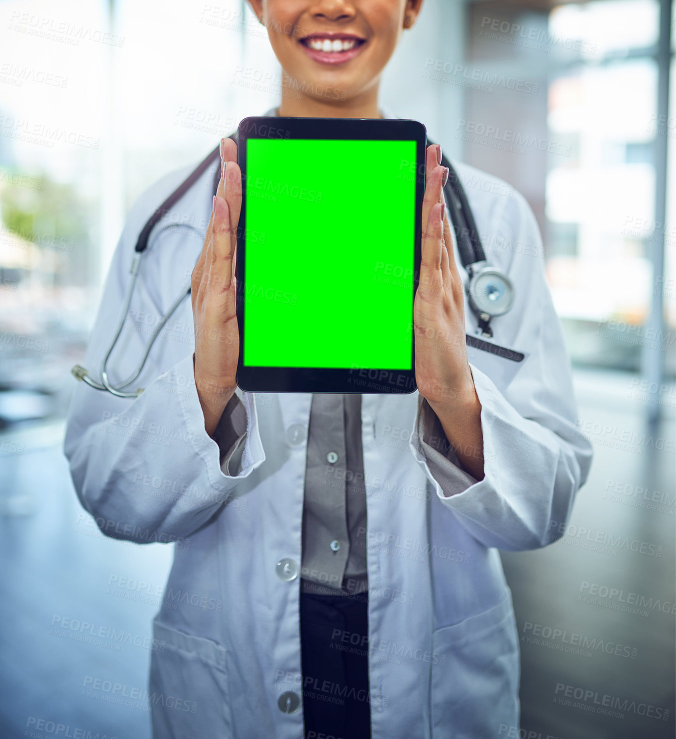 Buy stock photo Portrait of a young female doctor holding a digital tablet with a chroma key screen