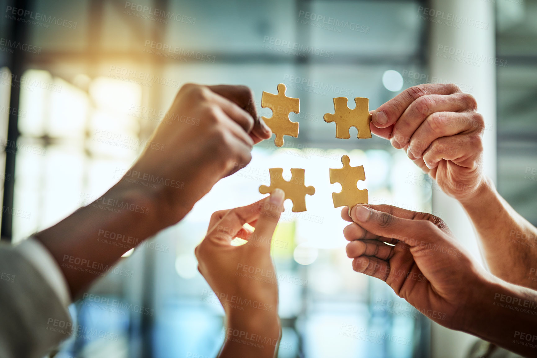 Buy stock photo Group of business people holding puzzle pieces. Professionals connect and collaborate together inside office building. Closeup of hands, and team working together on a new strategy for success.
