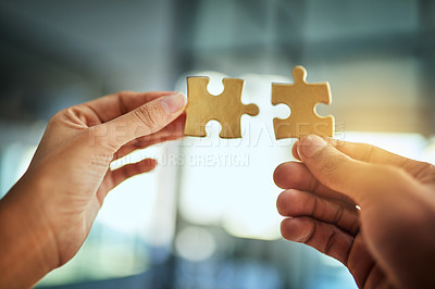 Buy stock photo Puzzle, teamwork and innovation while people fit jigsaw pieces together in an office. Business solution, strategy and success while plans come together. Connection, partnership and building trust