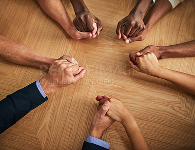 Buy stock photo United, support and trust by business people holding hands in a circle from above. Community, teamwork and collaborating professional coworkers showing strength in unity in a discussion or meeting