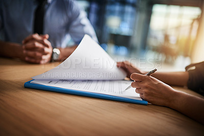 Buy stock photo Cropped shot of a man and woman completing paperwork together at a desk